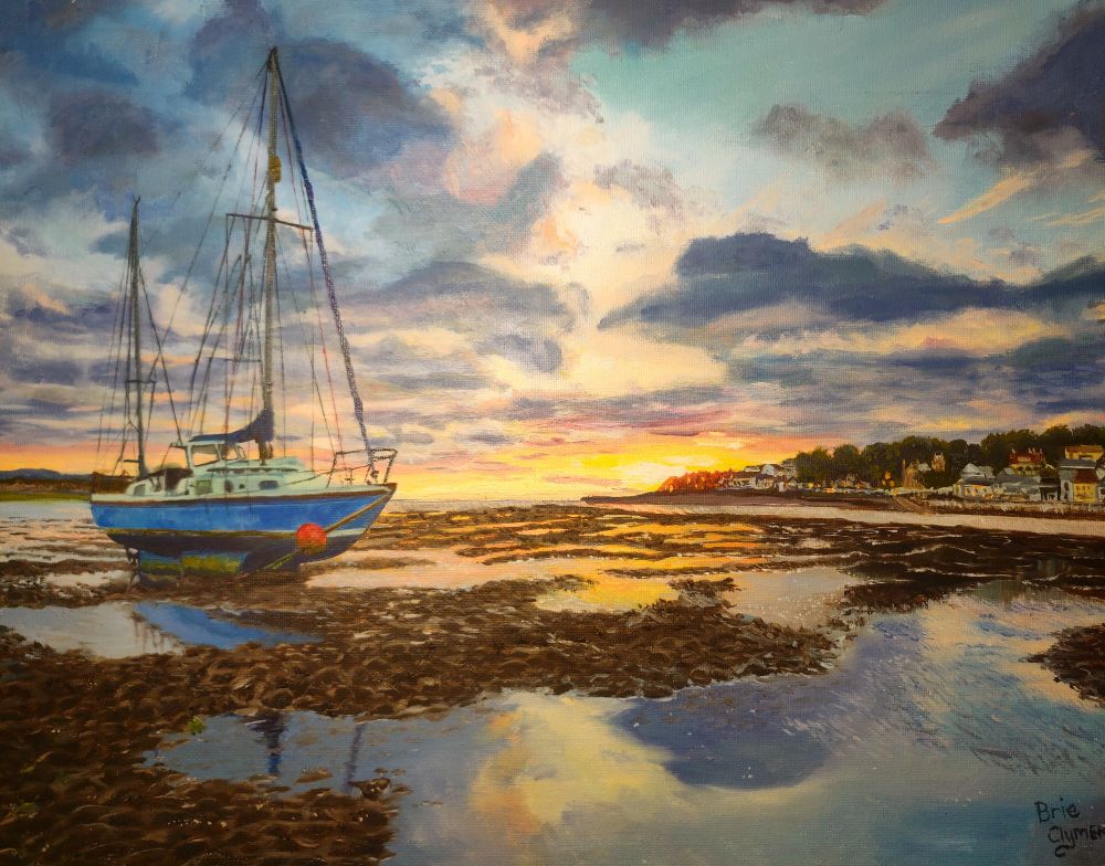Painting of a boat beached in the shallows on low tide. The sailboat is gently leaning on its side in the sunset with a small town in the background and water reflecting the sky in pools on the beach.