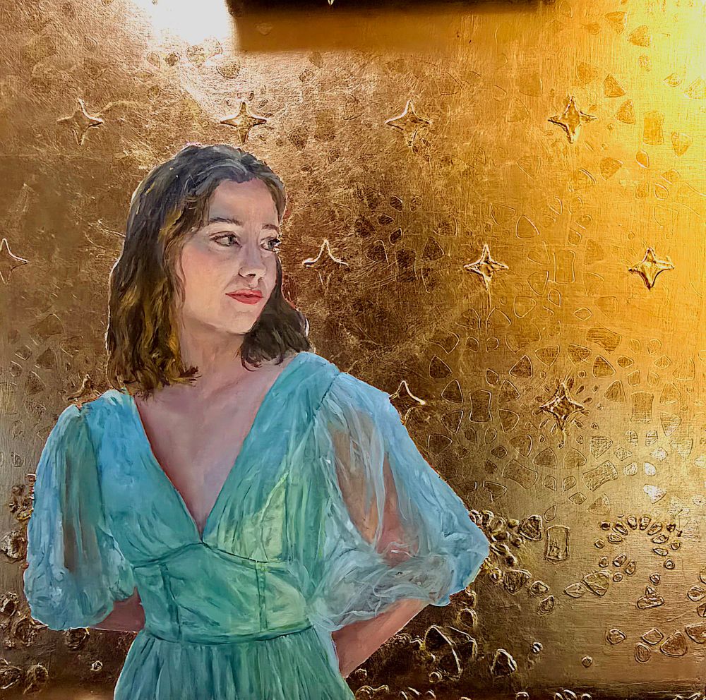 Oil painting of a young woman in April romantic flowy dress with gauzy sleeves in a glowy green color. Her face is under lit by a gentle golden light and she is looking to her left. She is seen from the waist up and the background is made from 23 carat gold filled it onto the artboard. There's a pattern that can be seen in the gold that is burnished to be reflective. There are also raised stars underneath the gold for a 3D effect