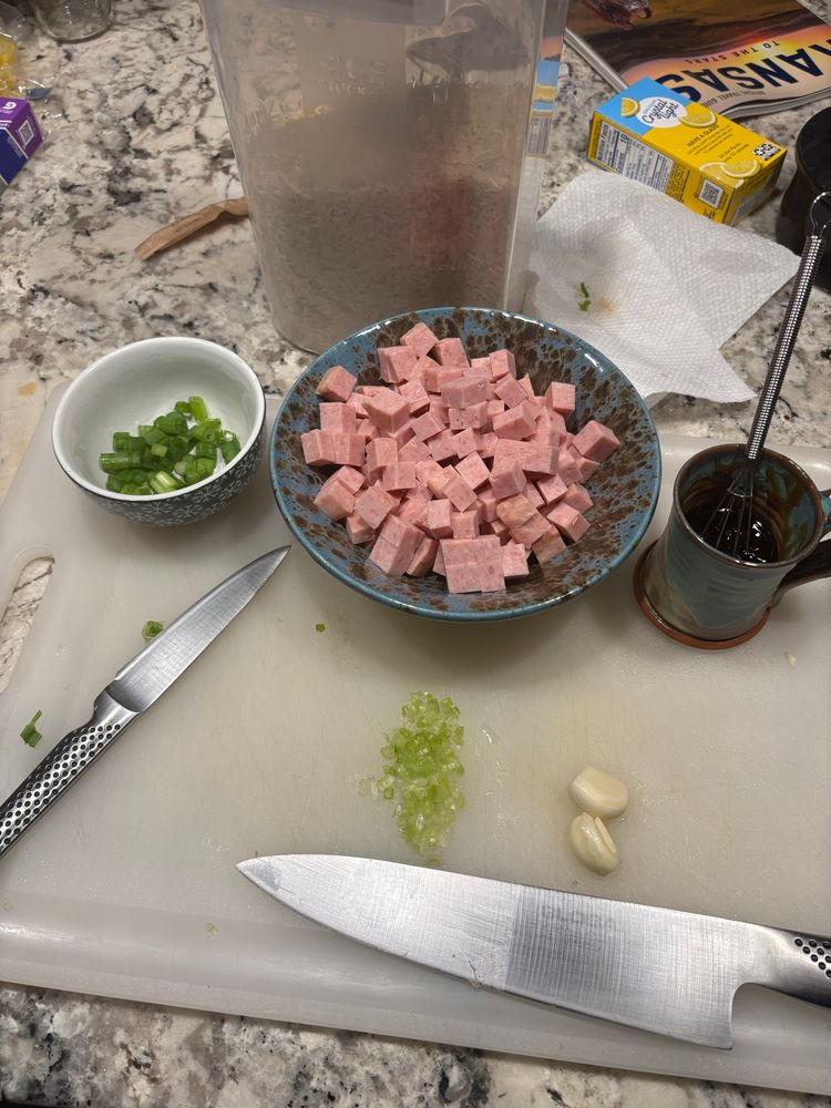 mise en place for spam fried rice - green onion, spam, garlic, soy +mirin+oyster, all on a cutting board 