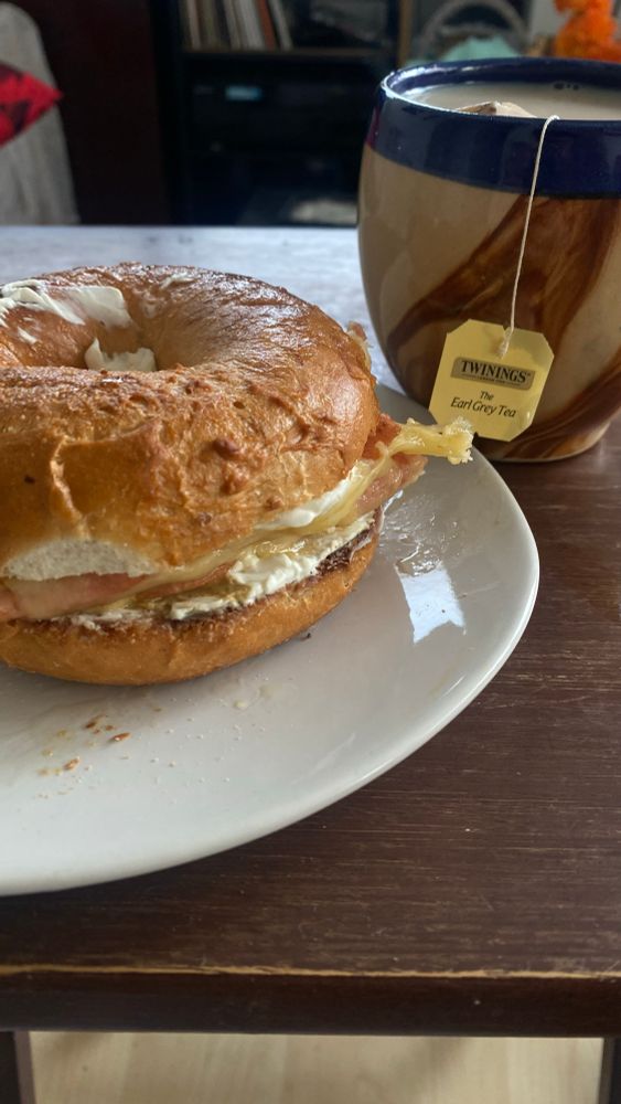 a creams cheese bagel with a cup or tea. 