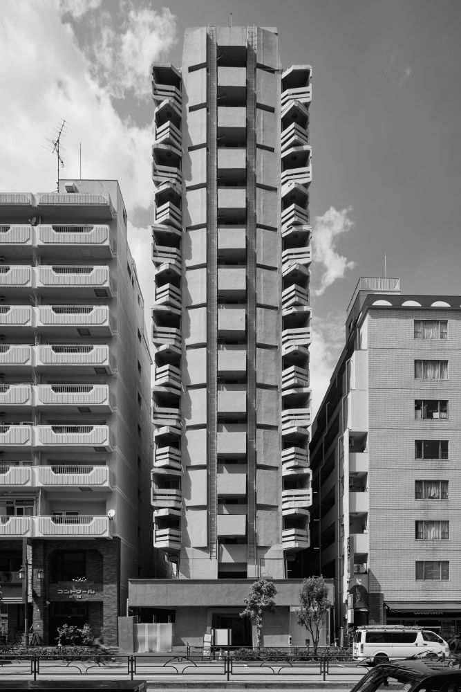 Black and white photo of a tall, narrow building with a battleship-like exterior.