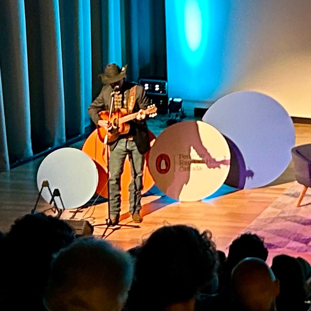 Corb Lund opens a Wordfest event with a song. 