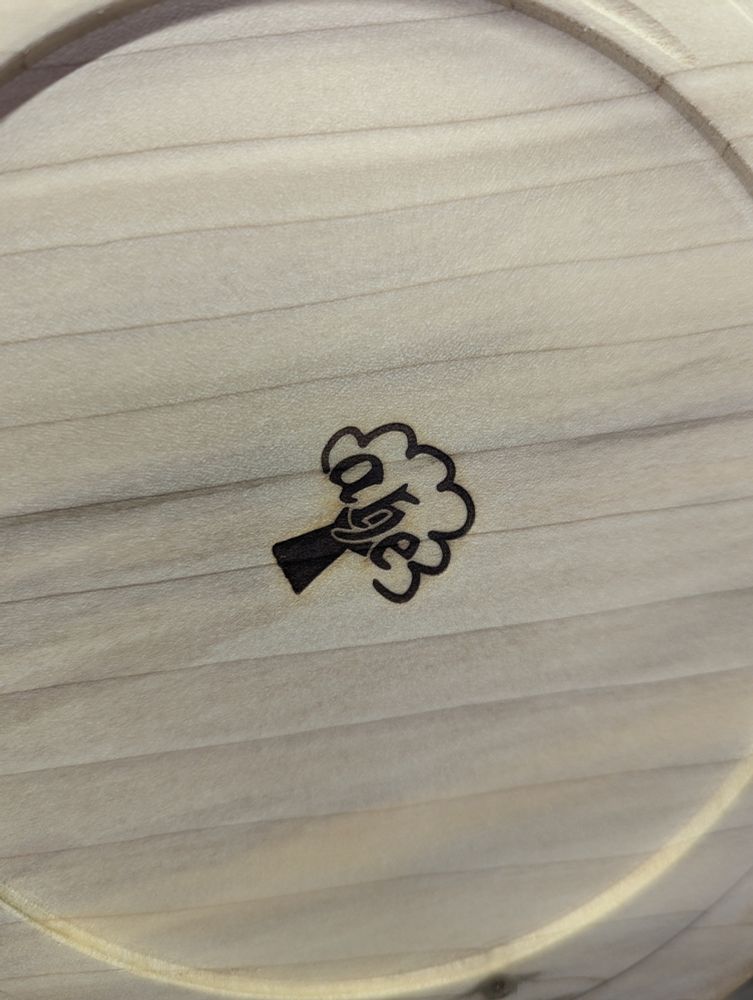 Photograph of the base of a bowl with a burned in logo (stylised tree with initials ahe) that is crisp and has nice separation of the dark and light areas.