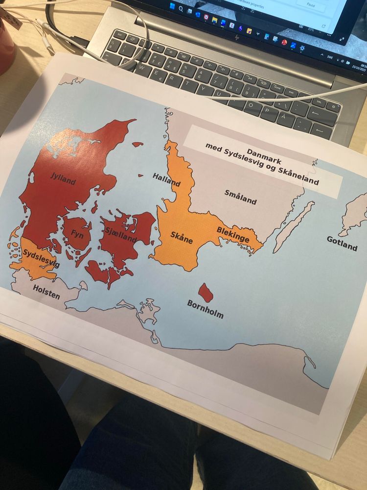 A printed map of Denmark and South Sweden. The areas are colored in different shades.  