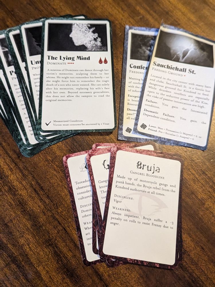Sets of tarot sized cards containing the text for VtR disciplines, bloodlines, and feeding grounds.