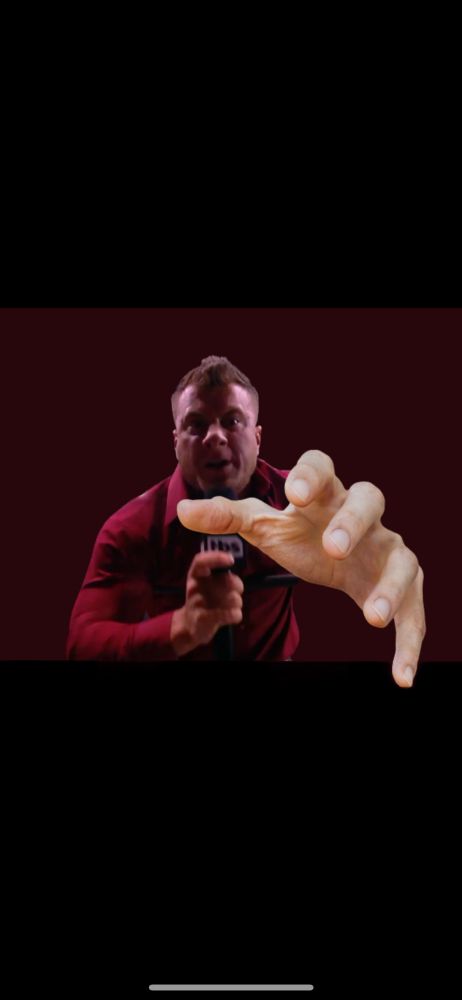 Meme image of wrestler MJF holding a mic in one hand and reaching the other clearly-photoshopped hand seemingly through the screen