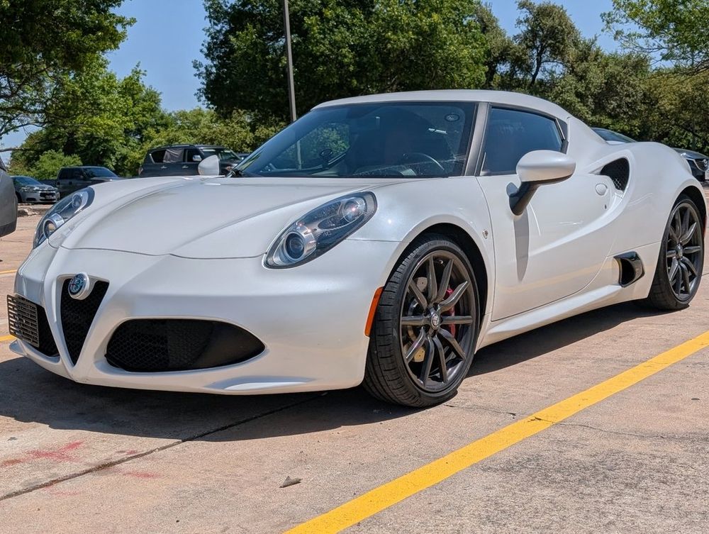 A white Alfa Romeo 4C coupe with no license plates on