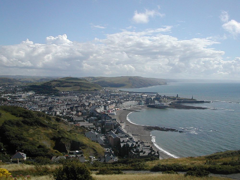 https://en.wikipedia.org/wiki/Aberystwyth#/media/File:Aberystwyth_shore.jpg - looking south over Aberystwyth on a sunny day.