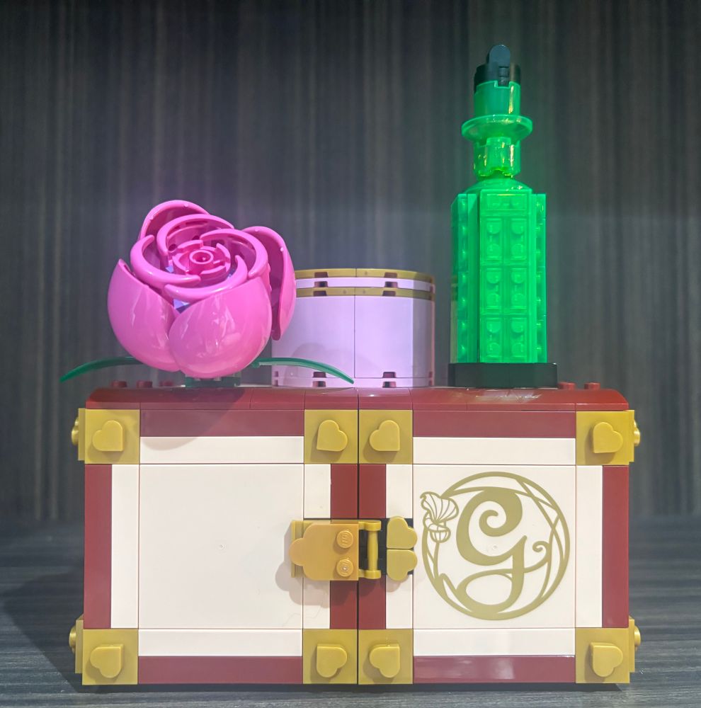 the outside of a lego doll house based on the wicked movie. it looks like a box for storing jewelry but opens up to reveal a model of the dorm rooms from the film