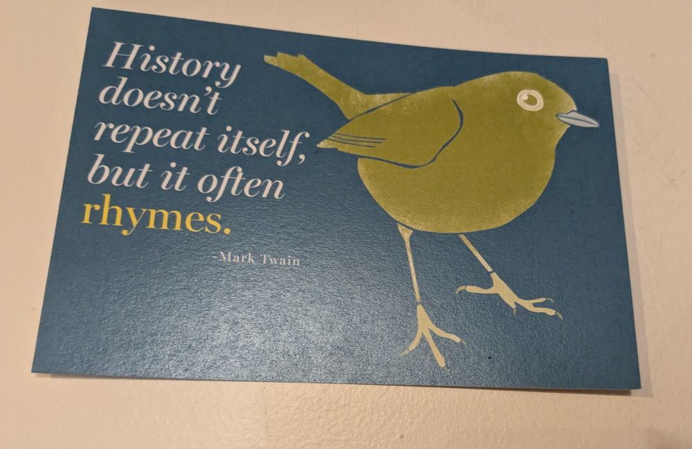 Drying of a green bird on a black background with the words history doesn't repeat itself, but it often rhymes. Attribution Mark Twain