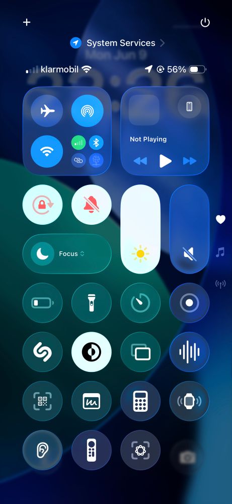 Screenshot of control center in new ios 26 developer beta, with all the icons being rounded and the new “living glass” style