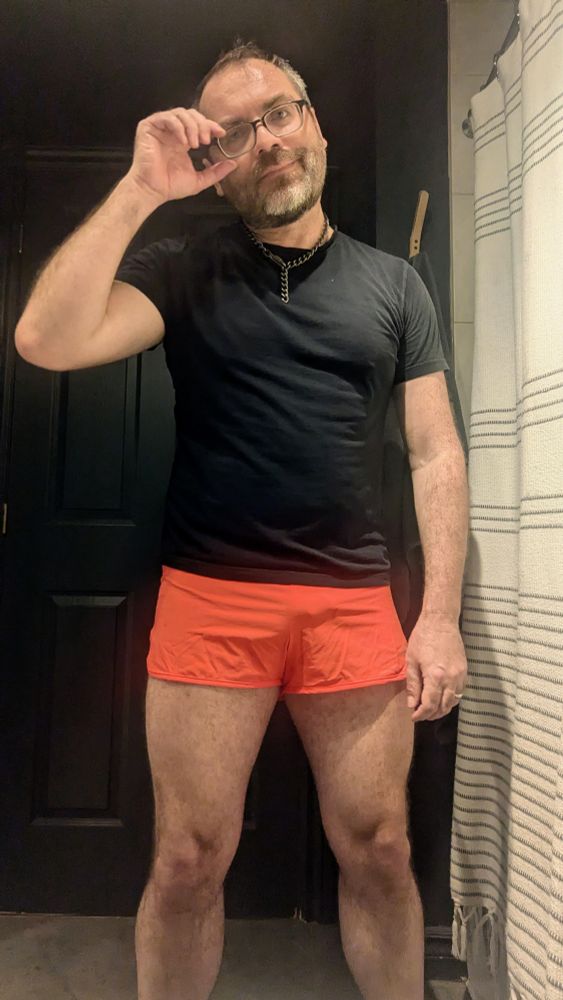 I'm wearing a black T-shirt and orange short shorts