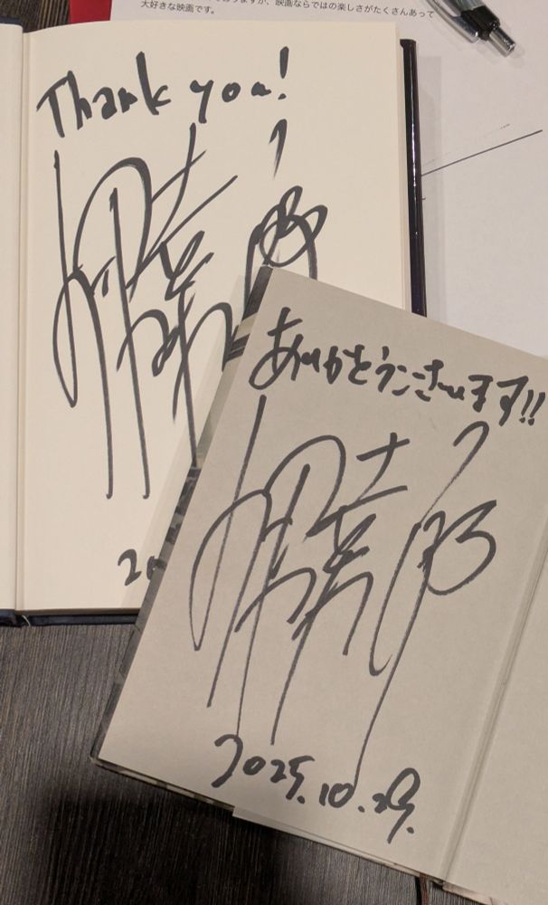 Both books now open to their front pages, where Isaka-san has signed them. One says Thank you! And the other saysありがとうございます!
 