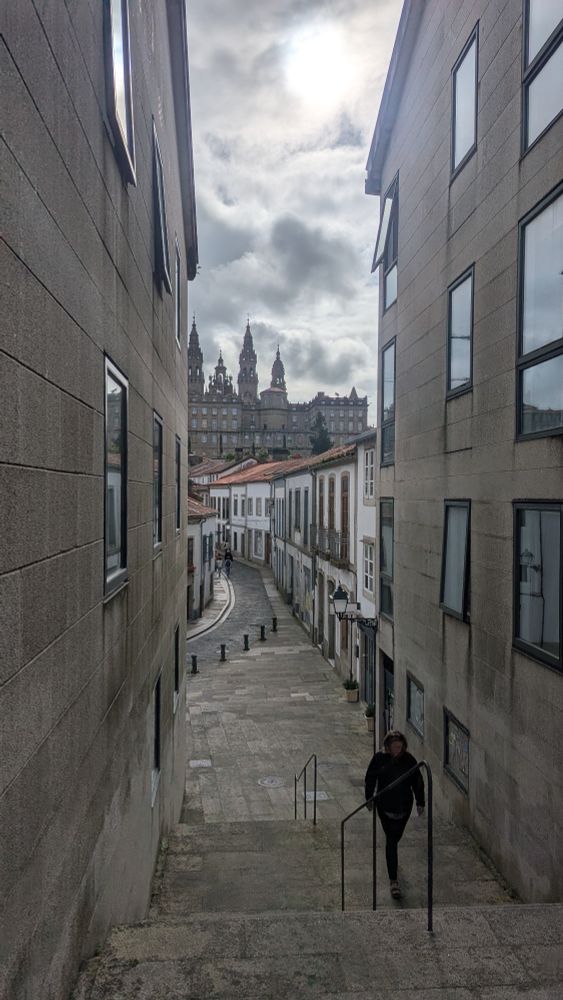 Photo of a street in Santiago de Compostela with Cathedral of St James rising above the rooftops.