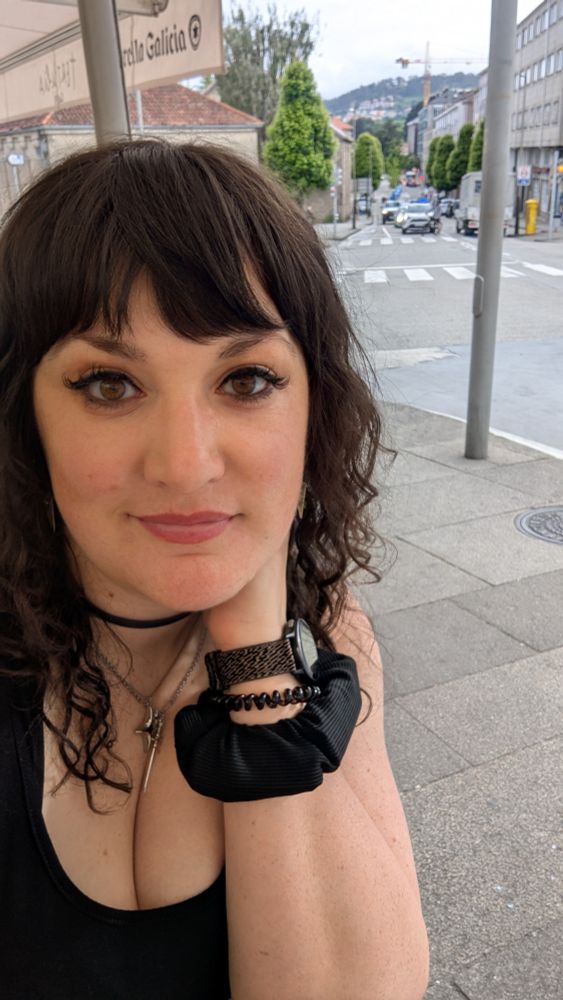 Selfie of Lukalock, a woman with brown eyes and dark wavy hair, sitting at a cafe in Spain.