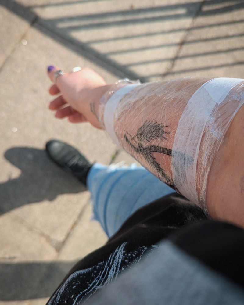 Photo of Lukalock's newly tattooed arm, wrapped and taped in cling film. 