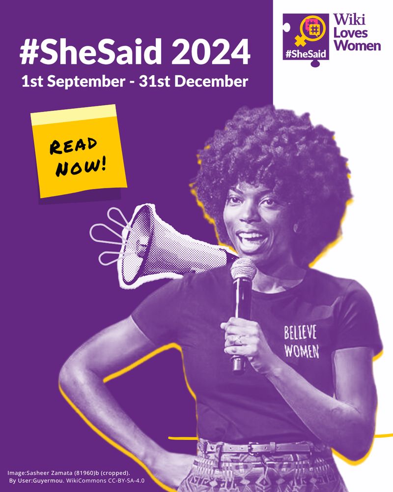 A women speaking into microphone with a megaphone behind her
