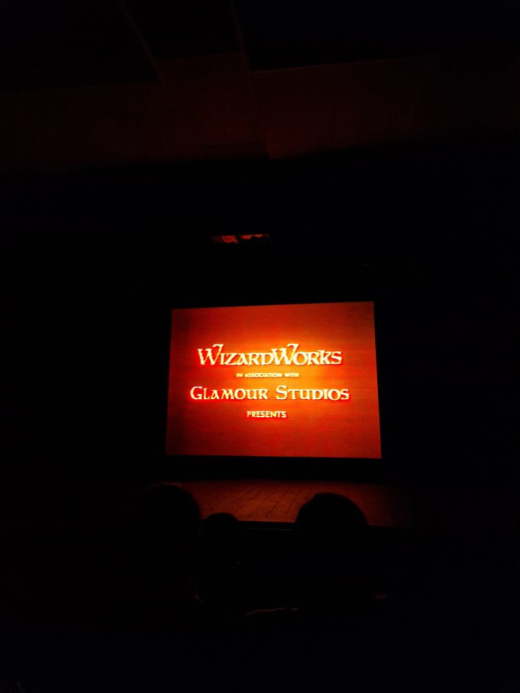 Photo of cinema screen with Wizard Works logo
