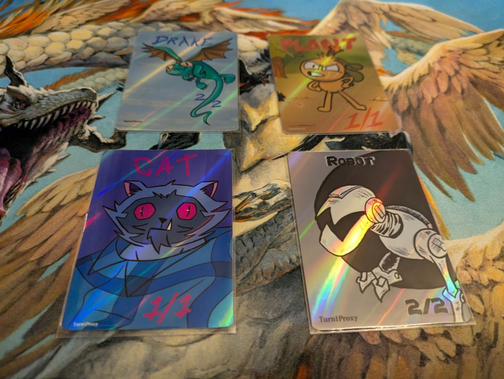 Custom Magic: The Gathering tokens made by Turn1Proxy!!

Top Left: Custom 2/2 Drake token
Top Right: Custom 1/1 Plant token
Bottom Left: Custom 1/1 Cat token
Bottom Right: Custom 2/2 Robot token