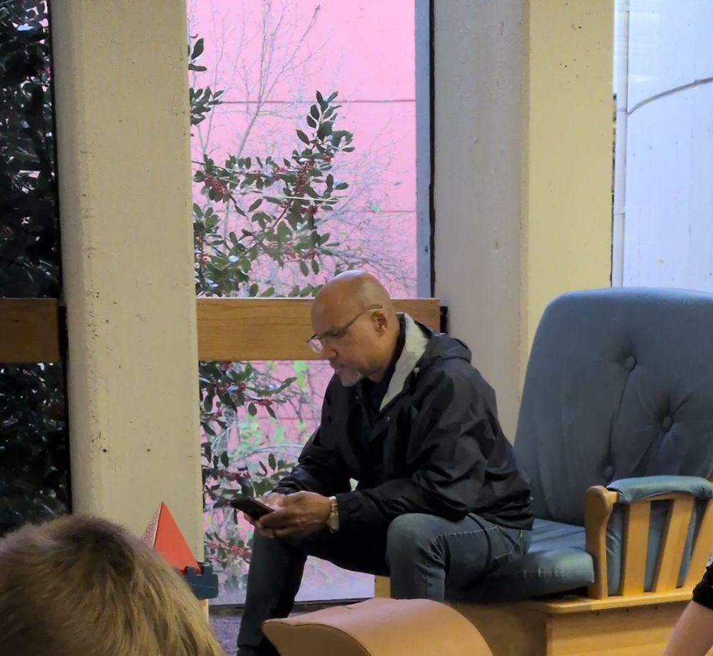 A man, who bears a bit of resemblance to fired PSU head football coach looking at his phone in the Towson branch of the Baltimore County Public Library 