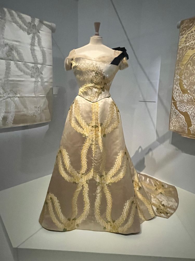 Yellow and white worth dress decorated with flower motifs 