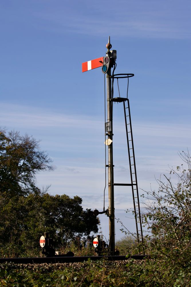 On a sunny late autumn day, lower quadrant semaphore AY3 stands at danger some way to the south of Abergavenny station and signal box. Alongside it are two ground discs.
