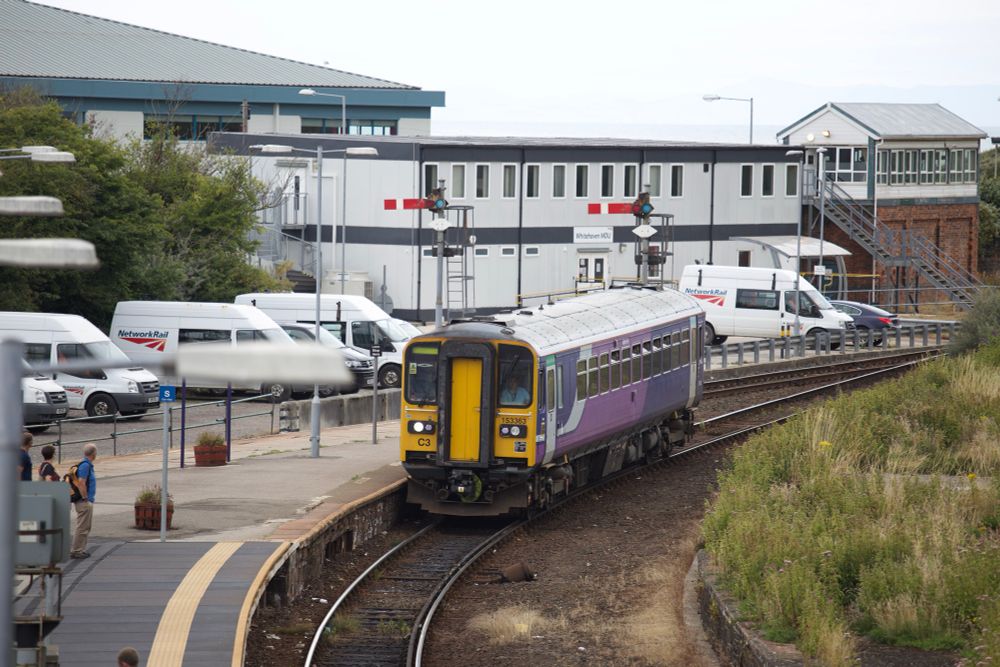 Northern DMU 153363 is coming to a stop at Whitehaven, working 2C30 Carlisle to - possibly - Lancaster. The semaphore signals at the end of the platform are both at danger. The substantial signal box is on the far right.