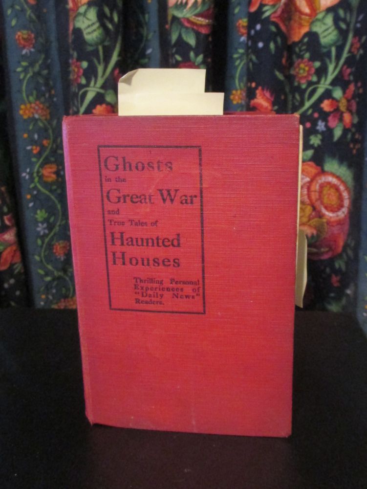 Red book in front of multicolored floral curtain
