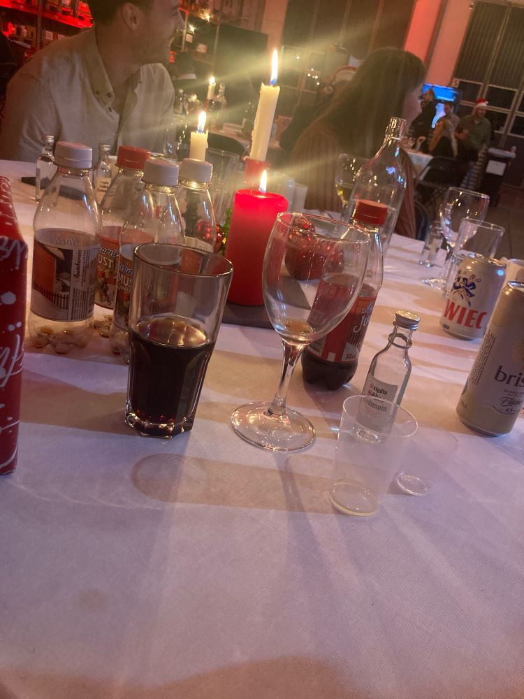 A photo of a finished Christmas dinner with some drinks at work.