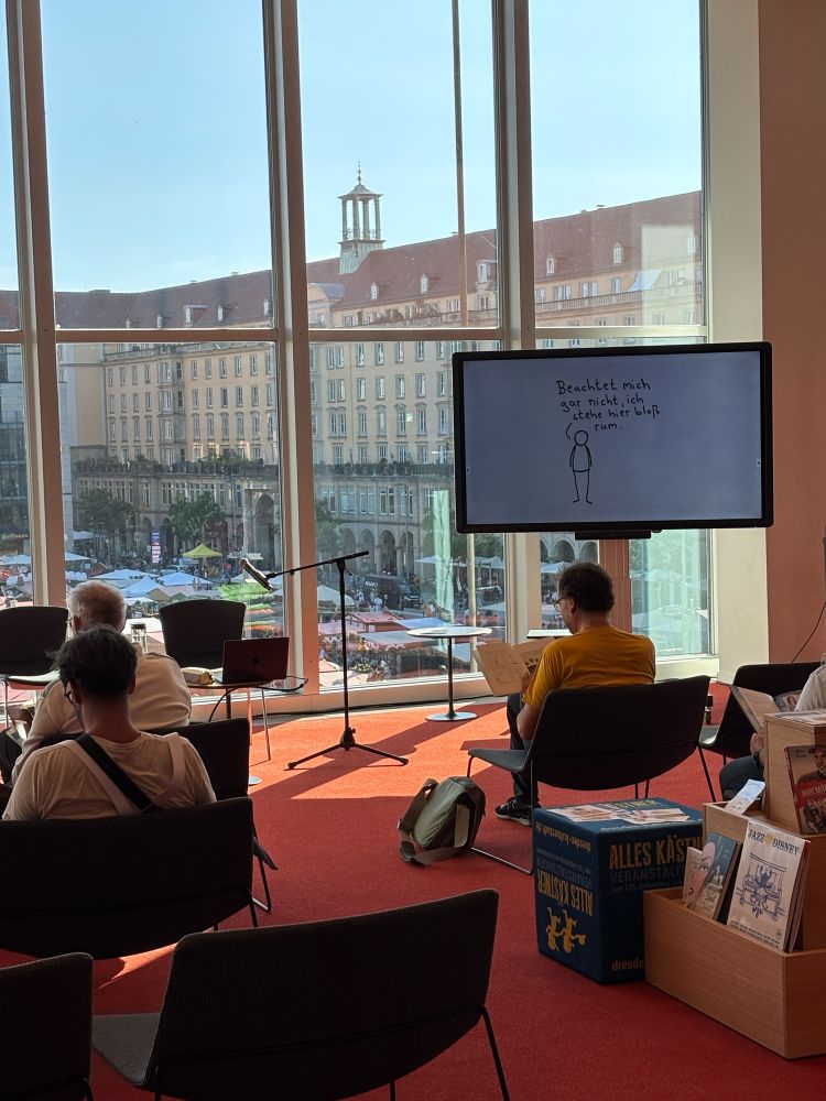 Fernseher mit Cartoon von mir vor Publikum.