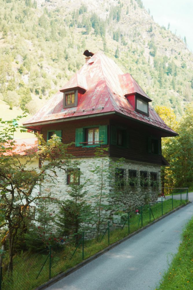 Uriges Haus vor Berg.