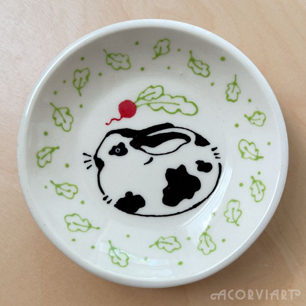 Small ceramic bowl with an illustration of a bunny surrounded by leaves and a radish