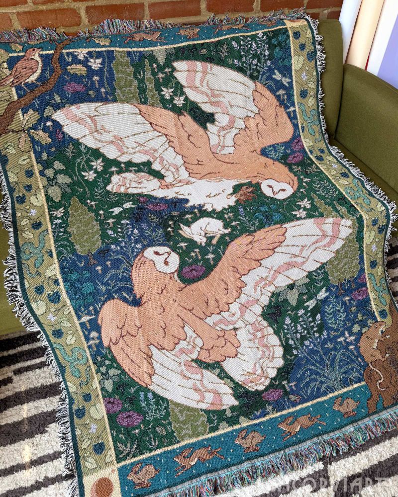The barn owl tapestry draped over a couch.
