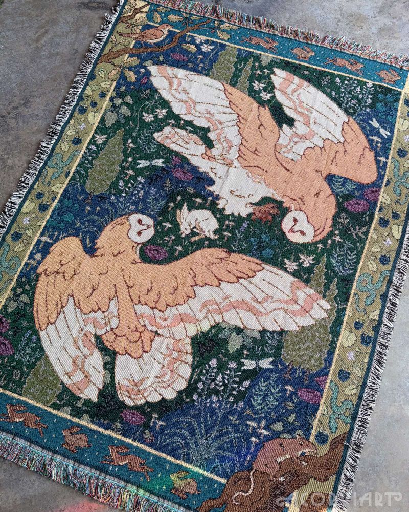 The barn owl tapestry flat on the floor.