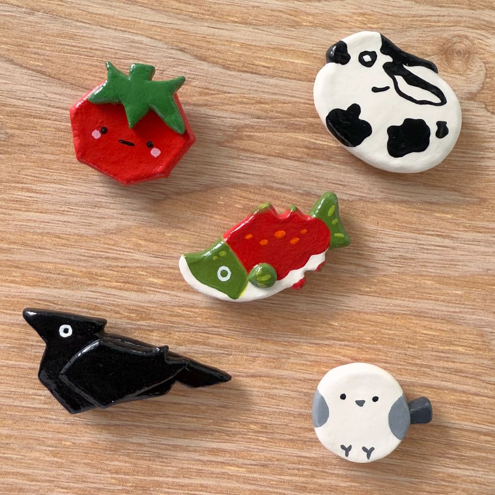 Air dry clay magnets of a tomato, bunny, salmon, crow, and tit (bird)
