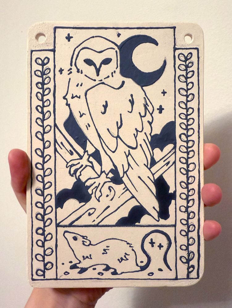 bisqueware wall hanging with an underglaze owl and rat drawn on it