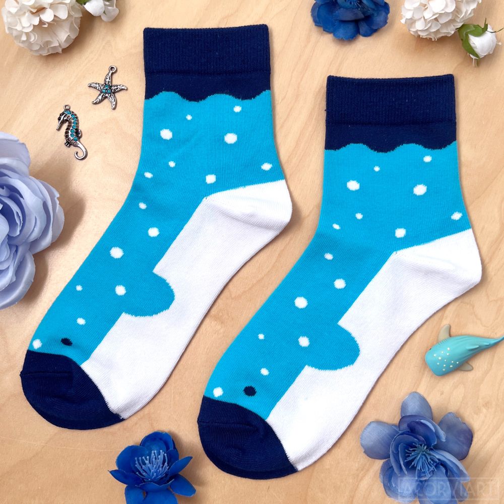photo of a pair of socks laid flat. the socks look like whale sharks