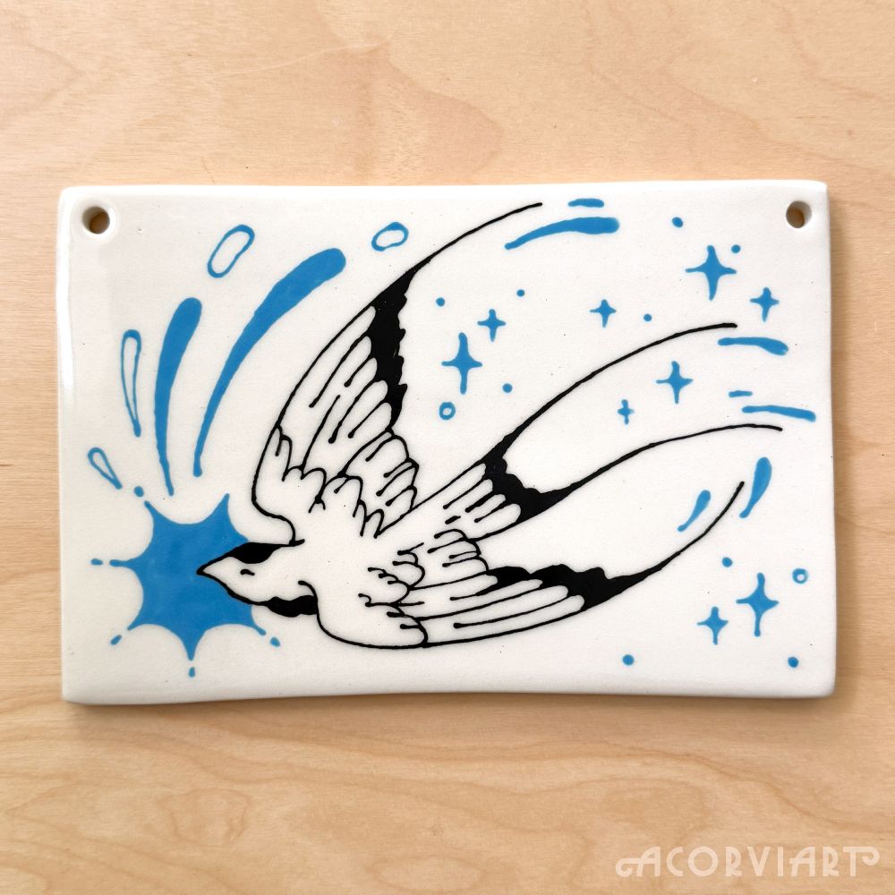 Ceramic wall hanging with an illustration of a swallow