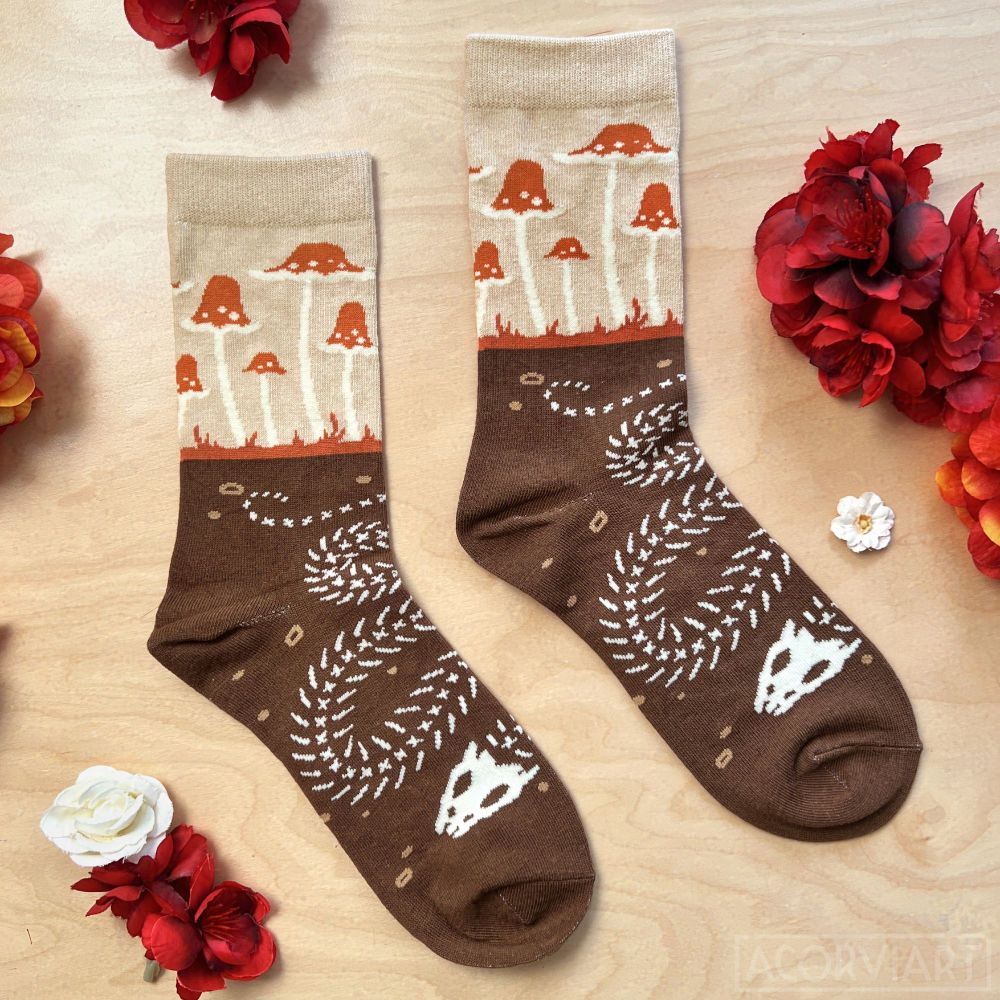 socks depicting mushrooms growing from the ankle areas (visible when wearing sneakers), with the rest of the foot depicting a buried snake skeleton