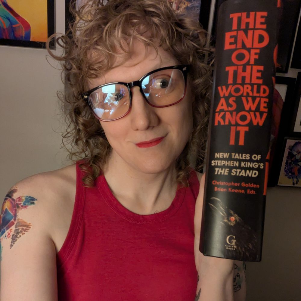 Hailey Piper, holding a copy of the same book sideways to show how thick it is (very!)