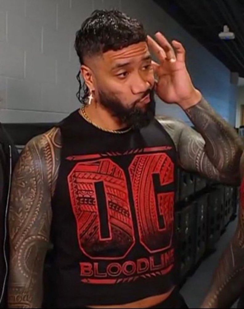 A visibly disappointed Jey Uso scratching his head.