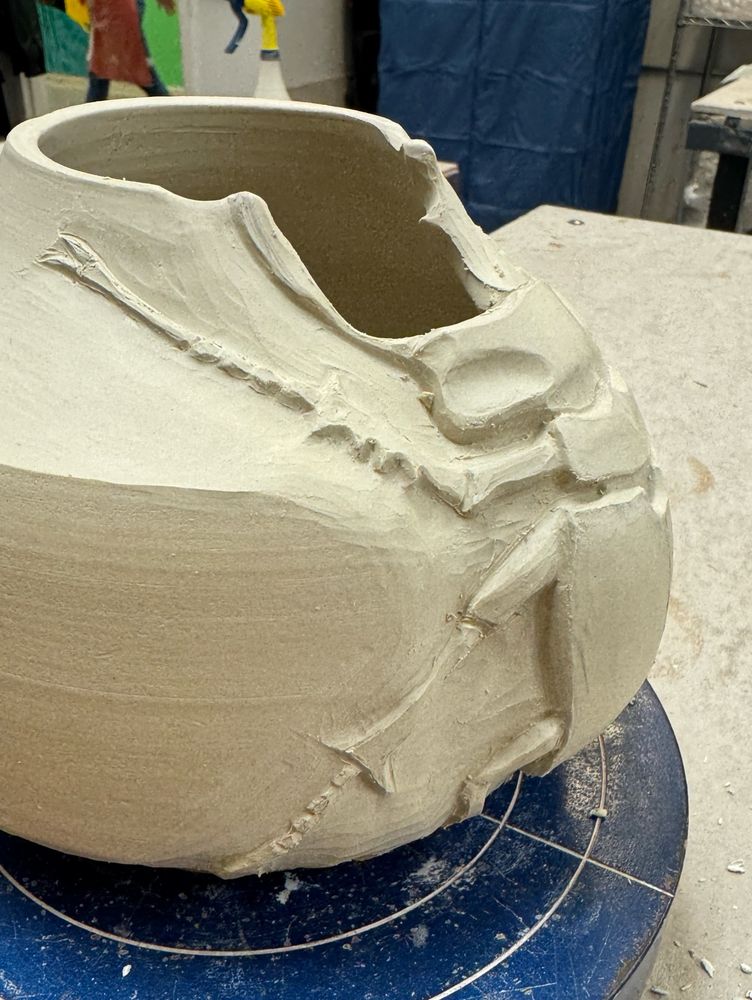 Side view of stag beetle pot sitting on a banding wheel