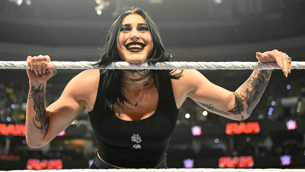 Goth pro wrestler Rhea Ripley smiling in the ring.
