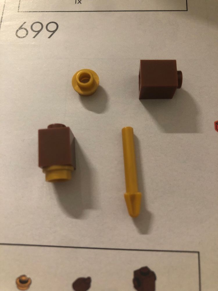 A single round Lego stud (incorrectly) attached to a tall square single stud Lego brick and a small Lego pole