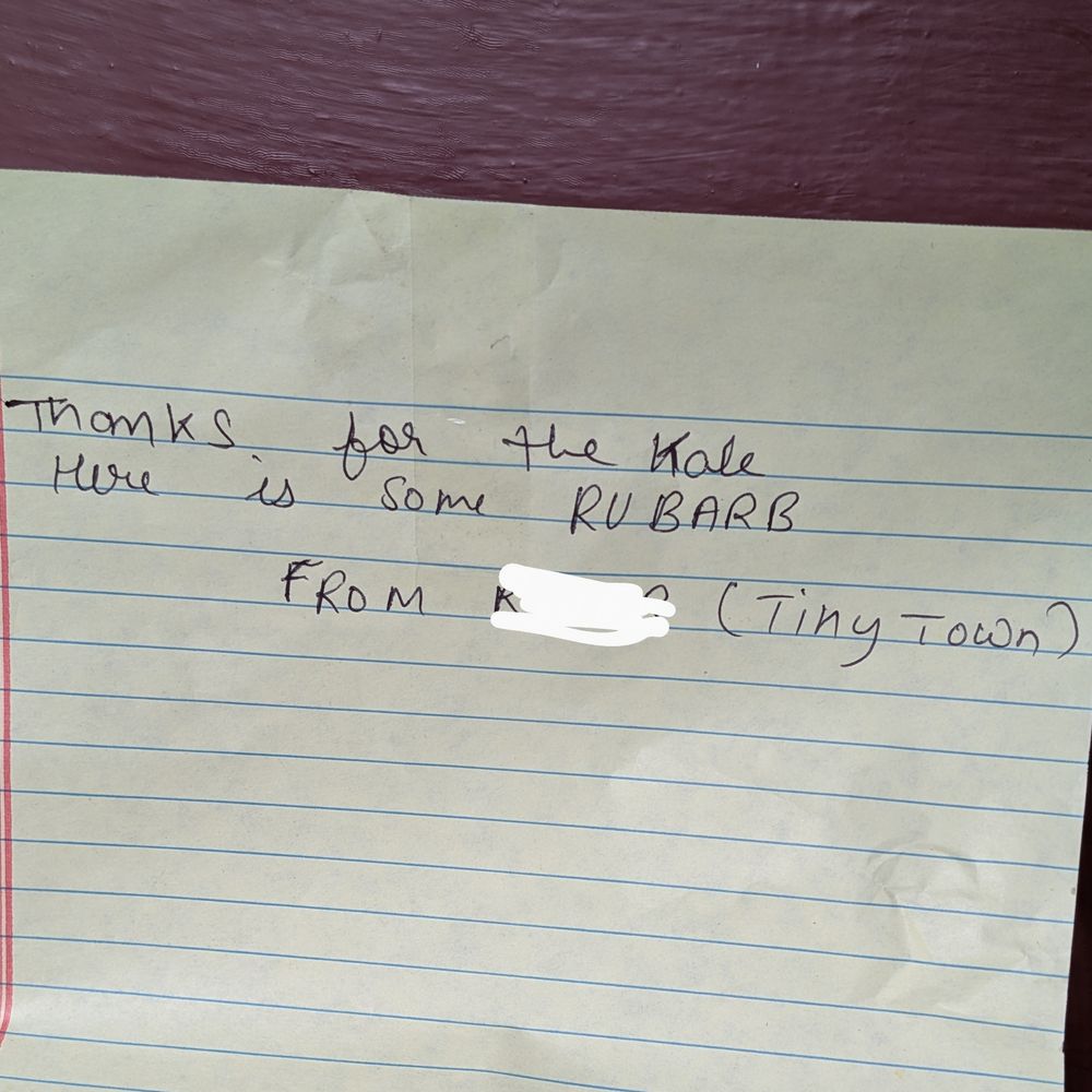 note reading "Thanks for the kale here is some rhubard. From (name redacted) Tiny Town. 