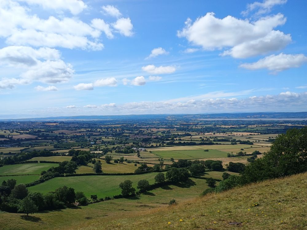 Photo taken from Coaley Peak looking across fields towards Sharpness and the river Severn.