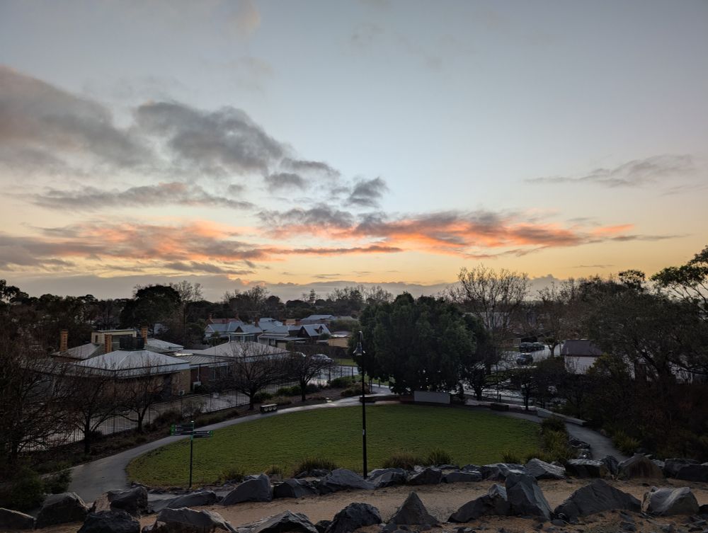sunrise from the small hilltop of a local park, with orange clouds