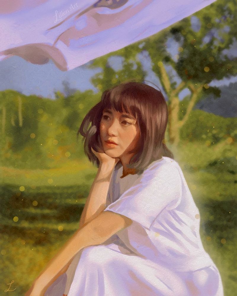 A woman sitting, thinking, in a beautiful landscape with a clothing line overhead.