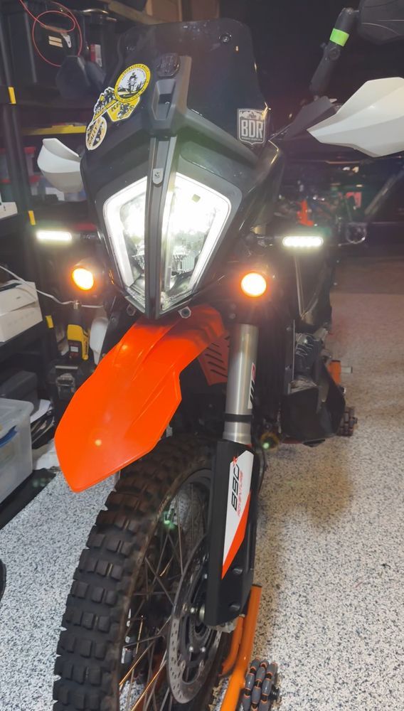 Picture of a KTM 890 motorcycle with headlights back in place all the fairings installed lights and components are working