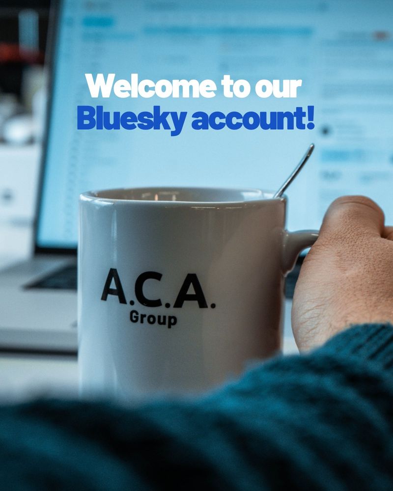 A hand holding a coffee mug with ACA Group logo